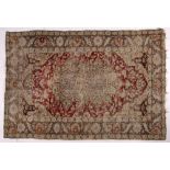 Persian red ground rug with central foliate medallion and banded border, 123cm x 82cm