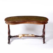 Kidney shaped desk with leather inset top Victorian, walnut, the stretcher with a padded footrest,