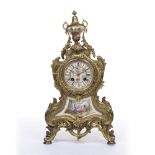 Gilt metal mantel clock, French, late 19th Century inset with porcelain panels, and having a