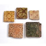 Five medieval tiles 14th/15th century, on a terracotta ground, of varying designs, largest 18cm