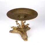 Brass centre stand of classical form with dolphin base, 23cm diameter, 17.5cm high