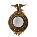 Small gilt convex mirror early 19th Century, with eagle mount, 42cm x 24cm