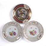 Pair of Meissen plates decorated with flowers and insects to the centre surrounded by an openwork