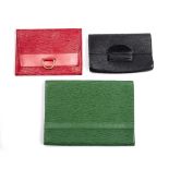 Three Louis Vuitton clutch purses in epi leather, the large green example 36cm x 26cm, the red