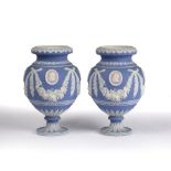 Pair of Adams jasperware urns circa 1830, decorated with pink cameos around the body with foliate