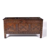 Carved oak coffer 18th Century, with three panelled top and sides, standing on stile feet, 127cm x