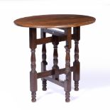 Heal & Son Ltd folding table, oak, with circular plaque to the table supports