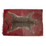 20th Century woven leopard skin rug, with fringed edges, 171cm x 117cm