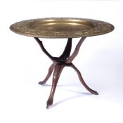 20th Century Indian brass top table, aesthetic style on carved hardwood stand, top measures 77.5cm
