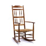 Attributed to Neville Neal for Ernest Gimson (1864-1912) Yew wood rocking chair with raffia seat,