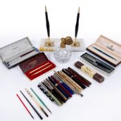 Group of Parker and other pens a desk stand and a glass and gilt metal atomiser Condition: at