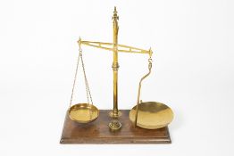Mahogany and brass balance scales by W & T Avery of Birmingham, on a mahogany base with various