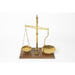 Mahogany and brass balance scales by W & T Avery of Birmingham, on a mahogany base with various