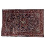 Persian blue ground rug, with central foliate medallion, trailing foliage and red ground border,