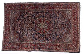 Persian blue ground rug, with central foliate medallion, trailing foliage and red ground border,