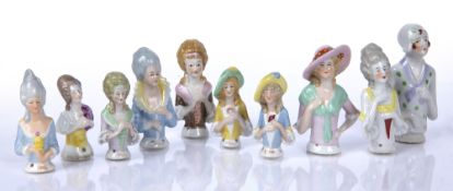Collection of porcelain pincushion ladies some with faint impressed numbers to the reverse (10)
