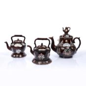 Three late Victorian Bargeware teapots the tallest with teapot finial and plaque reading 'A