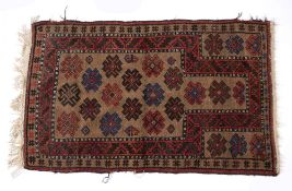 Pakistan rust ground rug with stylised medallions, 146cm x 89cm Condition: fraying to the edge and
