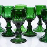 Group of twenty one green wine glasses possibly Scandinavian, each of fluted form with trumpet bases