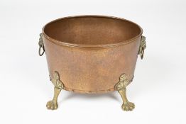 Copper and brass log bin with lion mask handles, standing on paw feet, 38cm x 30cm Condition: at