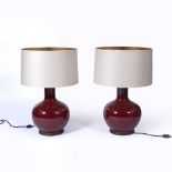Pair of ox-blood bottle vase lamps in the Chinese style, each with a metal base and shade, 82cm high