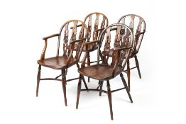 Set of four yew and elm wheel-back Windsor elbow chairs George III, each with three rail back and