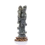 Soapstone model of Guanyin Chinese, the standing figure holding a lotus flower on a carved base,