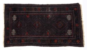 Large Beluch burgundy rug with three central medallions and panelled border, 240cm x 127cm