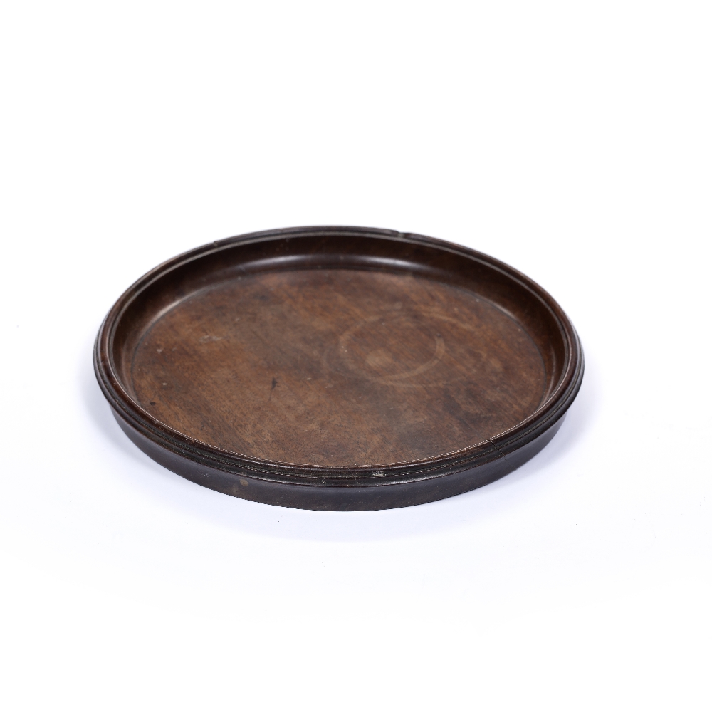 Mahogany small circular wine tray George III, of plain form 22cm diameter Condition: crack from edge