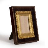 A LATE 19TH CENTURY GILT GESSO PORTRAIT MINIATURE FRAME, the border moulded with trailing vines,