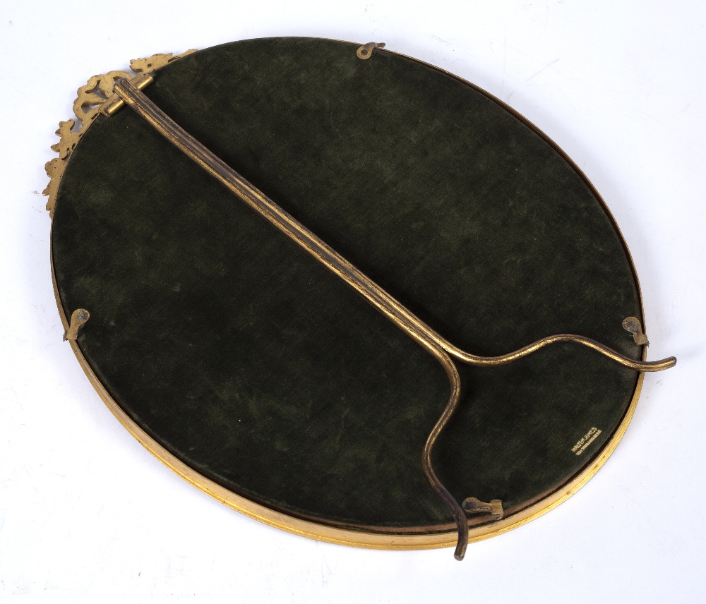 A GILT METAL OVAL PORTRAIT FRAME with ribbon swag cresting and easel support, green velvet back by - Image 3 of 3