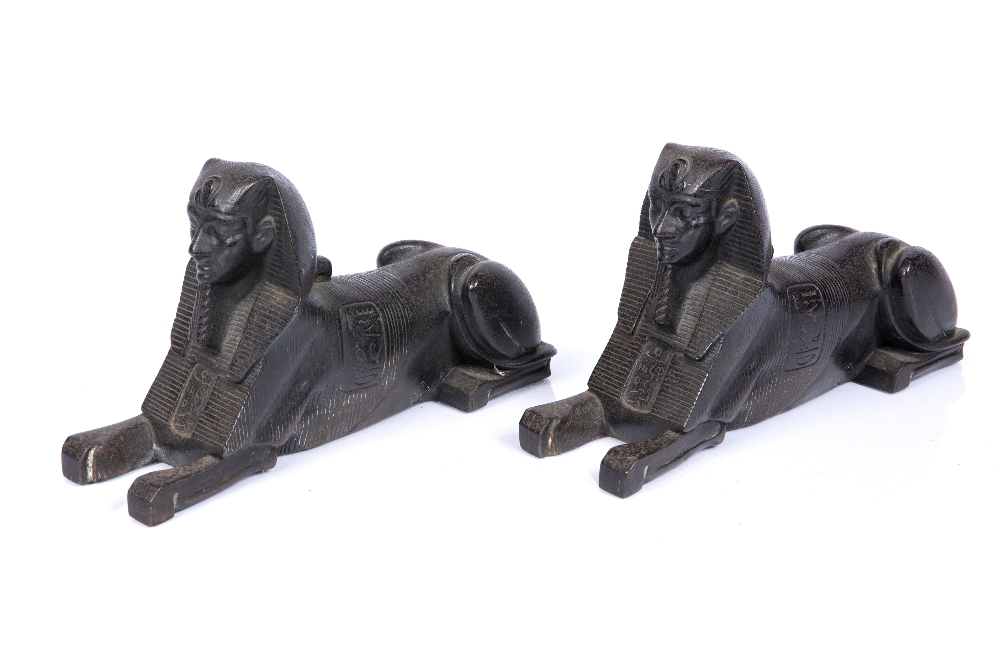 A PAIR OF 19TH CENTURY BRONZE RECUMBENT SPHINXES, each cast with textured and hieroglyphic