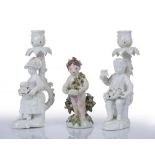 A PAIR OF DERBY WHITE GLAZED FIGURAL CANDLESTICKS, modelled with a boy with fruit and a girl with