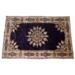 A KASHMIRI PURPLE GROUND RUG with central lotus bud medallion within a multiple polychrome border,