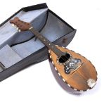 AN ITALIAN MANDOLIN with mother of pearl decoration and rosewood back, printed label inscribed '