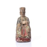 A LATE 17TH CENTURY CHINESE WOODEN FIGURE of a seated Lohan with traces of original and later