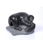 A CANADIAN INUIT ART CARVED GREYSTONE FIGURE GROUP of a polar bear with seal prey, 24cm wide