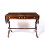 A REGENCY MAHOGANY SOFA TABLE, the top with a satinwood banded edge above two frieze drawers, twin