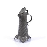 A GERMAN PEWTER FLAGON the hinged lid with heraldic crest, scroll handle, wrythen and wrigglework