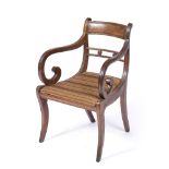 A REGENCY MAHOGANY OPEN ARM ELBOW CHAIR, the horizontal centre rail with carved florettes,