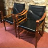 A PAIR OF SAFARI CHAIRS in the manner of Michael Hirst, with padded backs and seats, leather elbow