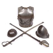 AN ANTIQUE STEEL BREAST PLATE with brass studs and leather trimmed rim, 41cm high, a Saxon style