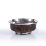 AN ANTIQUE SIMULATED WALNUT TURNED WOOD AND WHITE METAL MOUNTED MAZER BOWL, possibly indistinctly