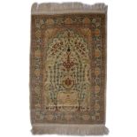 A TURKISH, HEREKE STYLE, SILK MAT decorated trees and flowers in pastel colours, 100 x 70cm