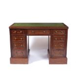 A VICTORIAN MAHOGANY KNEEHOLE PEDESTAL WRITING DESK with leather topped central drawer and one