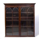 A GEORGE III MAHOGANY BOOKCASE, the top with moulded cornice above two lancet astragal glazed