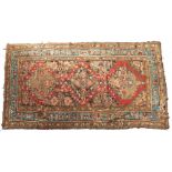 A CAUCASIAN RUG with triple medallion filled with florettes, wild beasts and formal designs, with