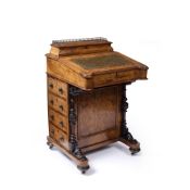 A MID VICTORIAN FIGURED WALNUT DAVENPORT with raised correspondence compartment, sloping leather