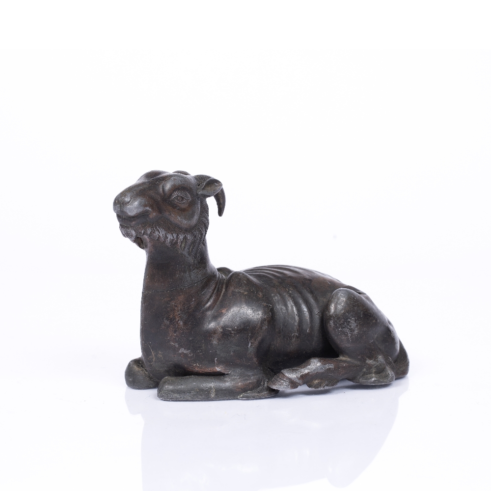 A CHINESE LEAD FIGURE of a recumbent goat, finely detailed, sheet composed with traces of brown