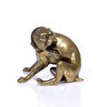 A BRONZE MODEL OF A SEATED HUNTING HOUND turning in a snarling expression with wide collar,